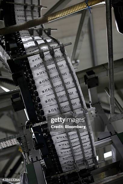 Newly printed editions of the Kathimerini daily newspaper roll through the automated production line at the Kathimerini Publishing SA printing plant...