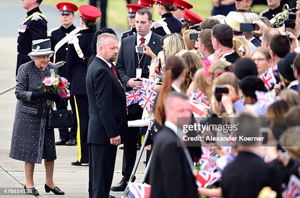 Queen Elizabeth II holds a bouquet of flowers during her arrival at the military airport of Celle on June 26, 2015 in Celle, Germany. The Royal...