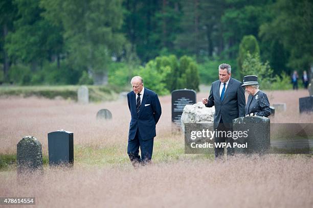 Queen Elizabeth II and Prince Philip, Duke of Edinburgh view the grave of Anne Frank during their visit of the concentration camp memorial at...