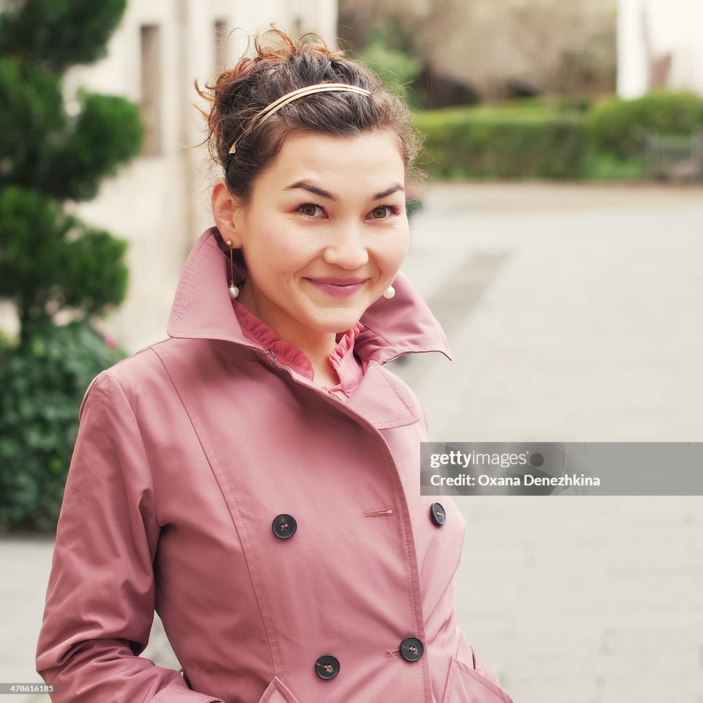 Beautiful young woman standing in the street