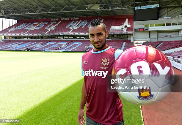 Dimitri Payet poses after signing for West Ham United at Upton Park on June 26, 2015 in London, England.