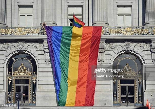 Rainbow flag is lowered over the front of City Hall after the U.S. Supreme Court ruled in favor of same-sex marriage in San Francisco, California,...