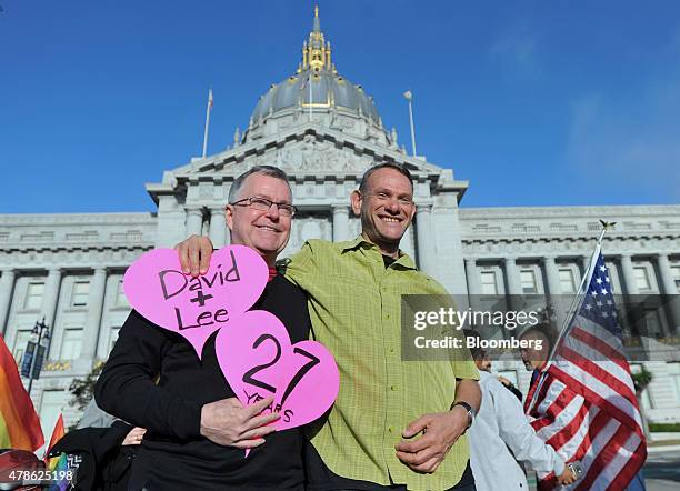 Lee Moulton, left, and David Fink, a couple of 27 years, smile outside of City Hall after the U.S. Supreme Court ruled in favor of same-sex marriage...
