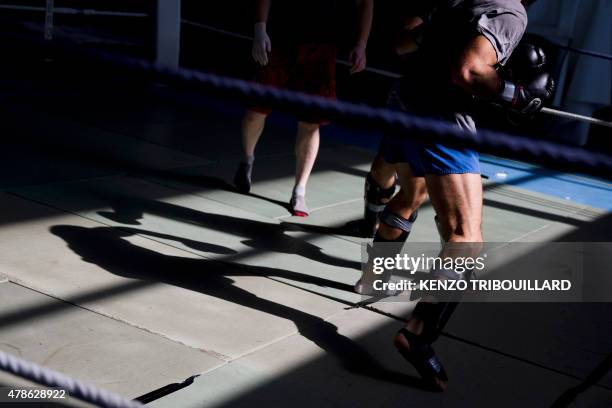 Two French gendarmes trying out for the National Gendarmerie Intervention Group pass an "aggression test" with a boxing bout on the last day of...