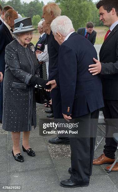 Queen Elizabeth II talks to contemporary witness Stefan Hertz during a visit to the concentration camp memorial at Bergen-Belsen on June 26, 2015 in...