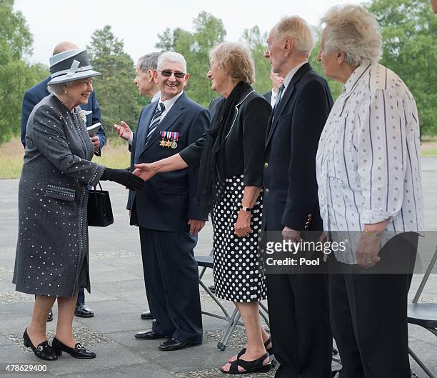 Queen Elizabeth II talks to contemporary witnesses Doreen Levy, Capt. Eric Brown and Anita Lasker-Wallfisch during a visit to the concentration camp...