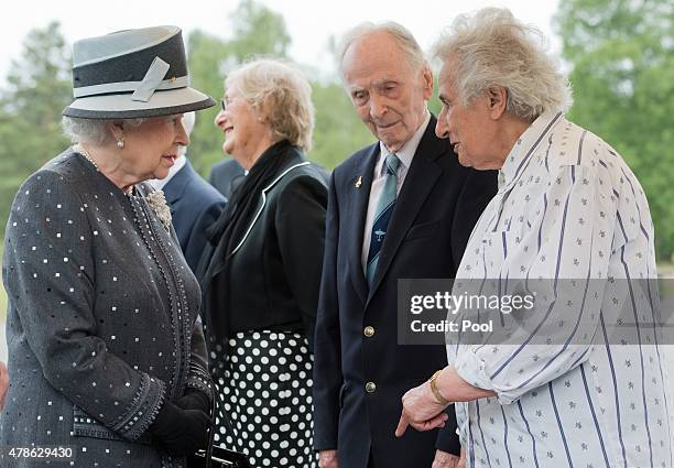 Queen Elizabeth II talks to contemporary witnesses Doreen Levy, Capt. Eric Brown and Anita Lasker-Wallfisch during a visit to the concentration camp...