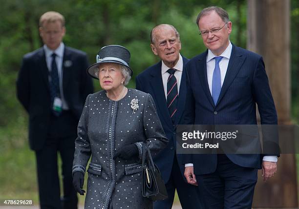 Queen Elizabeth II and Prince Philip, Duke of Edinburgh visit with Prime Minister of the state of Lower Saxony Stephan Weil the concentration camp...