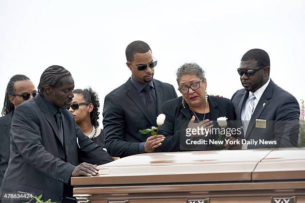 Sharon Risher, 2nd from right, and Gary Washington, left, pay their respects at the casket of their mother, Ethel Lance before her burial at the AME...