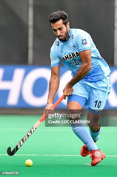 India's Dharamvir Singh controls the ball during the field hockey match between Pakistan and India in the men's Group A of the World League...