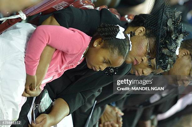 The wife of South Carolina State Sen. And Rev Clementa Pinckney, Jennifer, sits with daughters Malana and Eliana during his funeral, at the College...