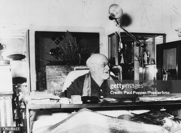 French artist Henri Matisse working on a table over his bed at his home in Cimiez, near Nice, France, 1st February 1951.