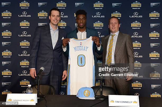 The seventh selection in the 2015 NBA Draft Emmanuel Mudiay of the Denver Nuggets poses for a photo with Team President Josh Kroenke and General...