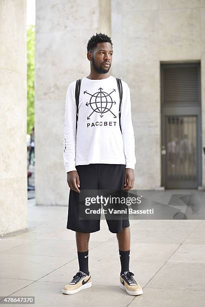 Akhim Ifasso poses wearing a Gosha Rubchinskiy shirt, Acne pants and Riccardo Tisci X Nike shoes on June 26, 2015 in Paris, France.