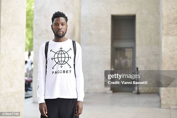 Akhim Ifasso poses wearing a Gosha Rubchinskiy shirt and Acne pants on June 26, 2015 in Paris, France.