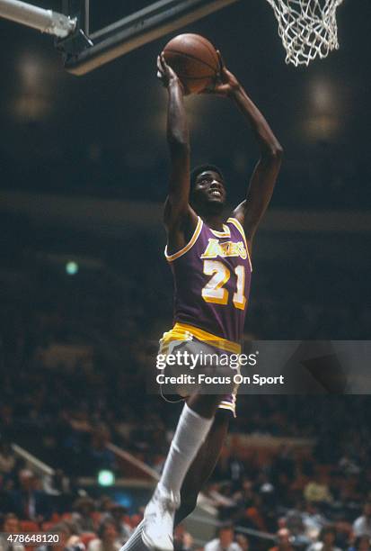 Michael Cooper of the Los Angeles Lakers goes up to slam dunk the ball during an NBA basketball game circa 1980. Cooper played for the Lakers from...