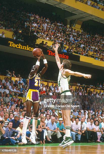 Michael Cooper of the Los Angeles Lakers shoots over Danny Ainge of the Boston Celtics during the 1984 NBA Finals at The Boston Garden in Boston,...