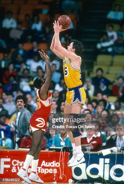 Mitch Kupchak of the Los Angeles Lakers shoots over Johnny Davis of the Atlanta Hawks during an NBA basketball game circa 1986 at The Forum in...