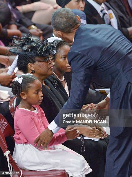 President Barack Obama greets Malana and Eliana , the daughters of Rev. And South Carolina State Sen. Clementa Pinckney, as his wife Jennifer...