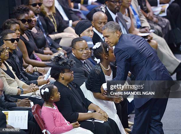 President Barack Obama greets Malana and Eliana , the daughters of Rev. And South Carolina State Sen. Clementa Pinckney, as his wife Jennifer...
