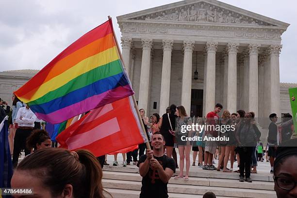 Hundreds gather outside of the Supreme Court on Friday to celebrate the decision to legalize gay marriage in all 50 states, in Washington, on June...