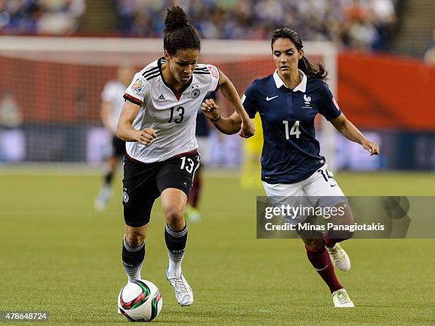 Celia Sasic of Germany moves the ball past Louisa Necib of France during the 2015 FIFA Women's World Cup quarter final match at Olympic Stadium on...