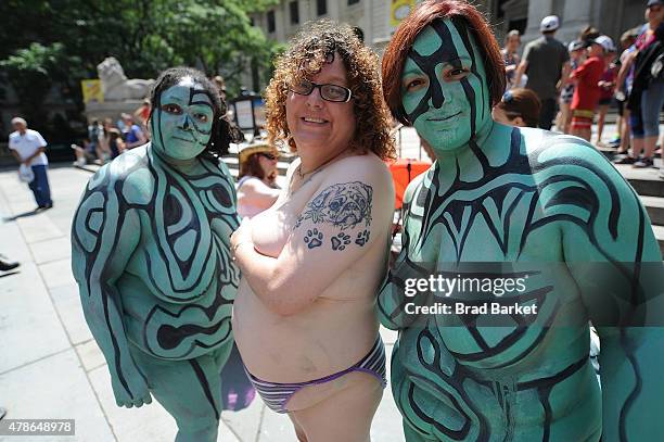 Models pose for a photo after being painted by artist Andy Golub duning Bodypainting day on June 26, 2015 in New York City.