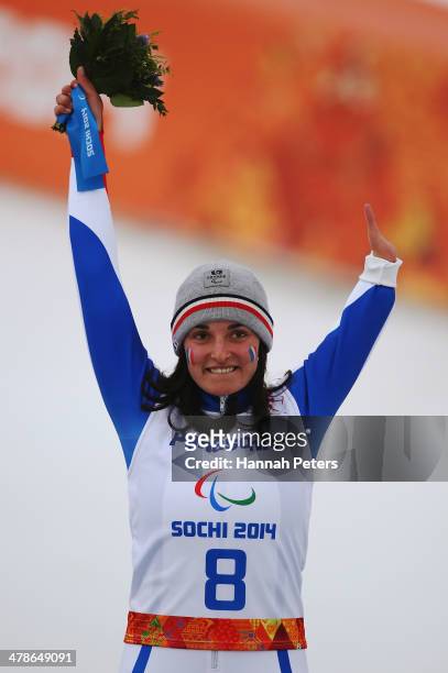 Gold medalist Marie Bochet of France celebrates during the flower ceremony for the Women's Super Combined Standing Super G during day seven of the...