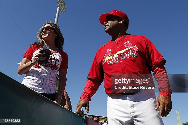 Coach Jose Oquendo of the St. Louis Cardinals speaks with a fan following a game against the Atlanta Braves at Roger Dean Stadium on March 13, 2014...