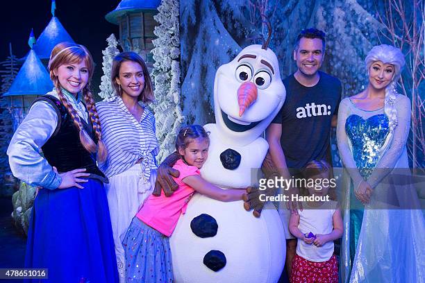 In this handout photo provided by Disney Parks, Jessica Alba and husband Cash Warren, along with daughters Honor and Haven pose with Anna, Olaf and...