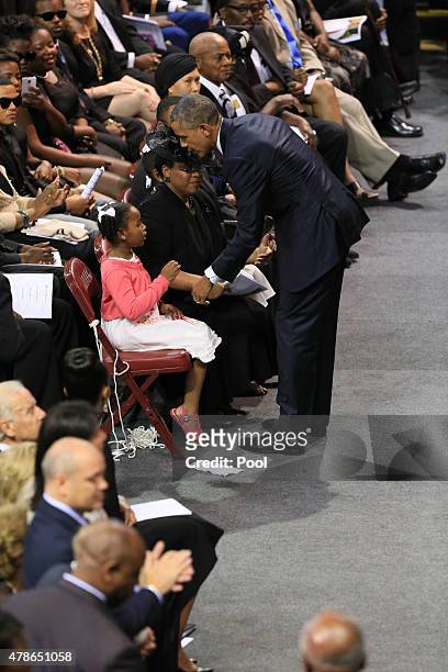 President Barack Obama embraces the family of Sen. Clementa Pinckney, who was killed during the mass shooting at the Emanuel African Methodist...