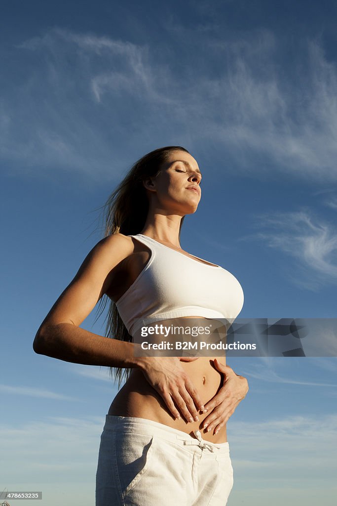 Young woman with her hand on stomach