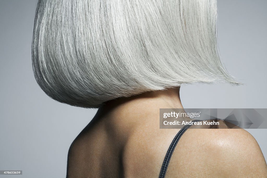 Profile of a grey haired woman in a bob, cropped.