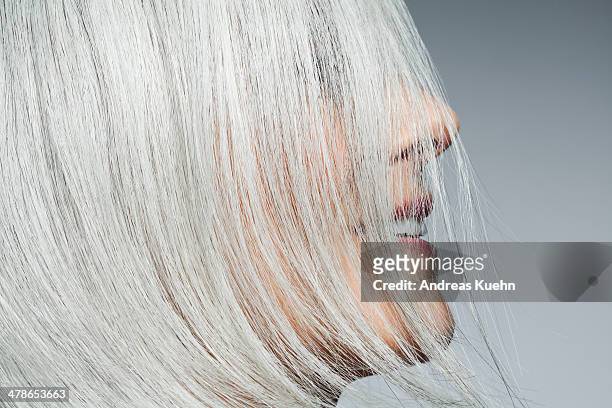 grey haired woman profile with hair covering face. - capelli grigi foto e immagini stock