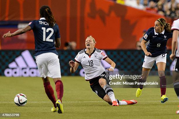 Jessica Houara of France trips Alexandra Popp of Germany during the 2015 FIFA Women's World Cup quarter final match at Olympic Stadium on June 26,...