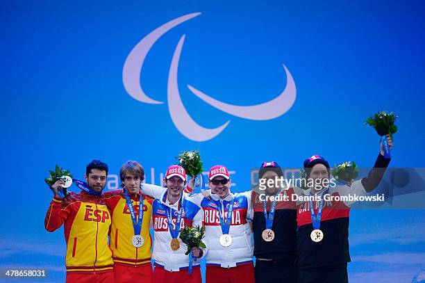 Silver medalists Yon Santacana Maiztegui and guide Miguel Galindo Garces of Spain, gold medalists Valerii Redkozubov and guide Evgeny Geroev of...