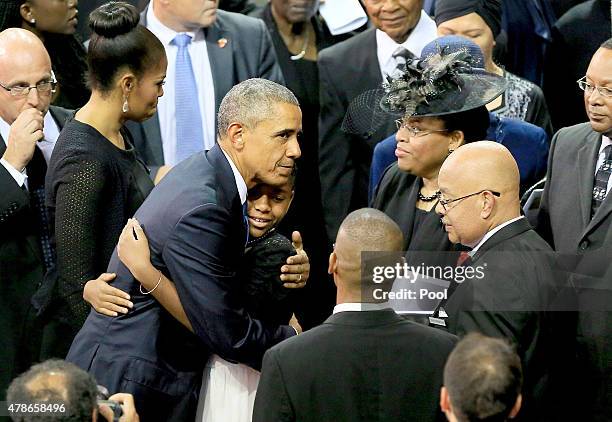 President Barack Obama embraces family members of Sen. Clementa Pinckney, who was killed during the mass shooting at the Emanuel African Methodist...