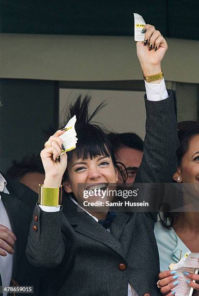 Lily Allen celebrates winning a bet in the Gold Cup during The Cheltenham Festival at Cheltenham Racecourse on March 14, 2014 in Cheltenham, England.