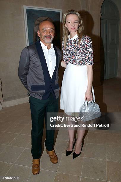 Christian Louboutin and Louis Vuitton's executive vice president, Delphine Arnault attend the Berluti Menswear Spring/Summer 2016 show as part of...