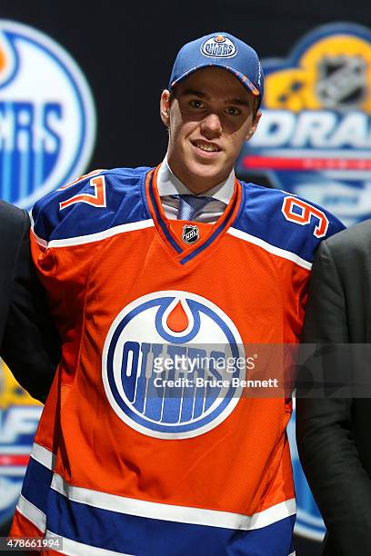 Connor McDavid poses on stage after being selected first overall by the Edmonton Oilers in the first round of the 2015 NHL Draft at BB&T Center on...