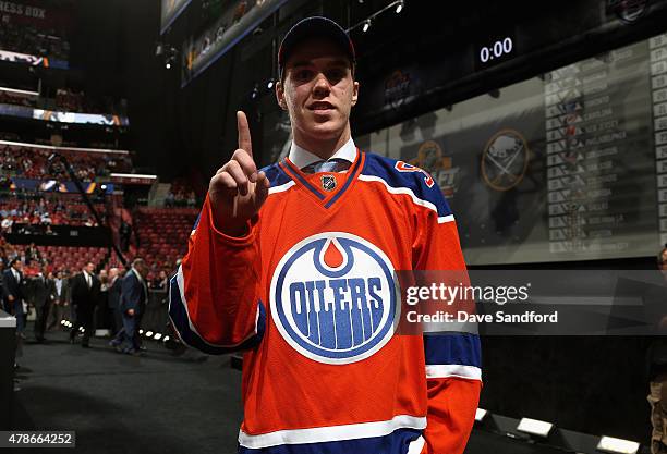 Connor McDavid signals number one after being selected first overall by the of the Edmonton Oilers during Round One of the 2015 NHL Draft at BB&T...