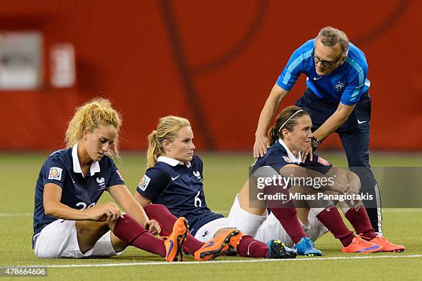 Members of France look on as Germany celebrates their victory during the 2015 FIFA Women's World Cup quarter final match at Olympic Stadium on June...