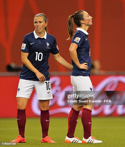 Camille Abily and Gaetane Thiney of France look dejected during the quarter final match of the FIFA Women's World Cup between Germany and France at...