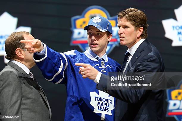 Head coach Mike Babcock of the Toronto Maple Leafs talks with Mitchell Marner after being selected fourth overall by the Toronto Maple Leafs in the...