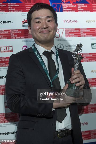 Directed by Kim Yuhna poses with the prize for best short film, "The method of surveillance sniper" at the closing ceremony for the 37th Moscow...