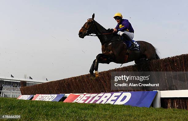 Davy Russell riding Lord Windermere clear an early fence before going on to win The Betfred Cheltenham Gold Cup Steeple Chase during Cheltenham Gold...