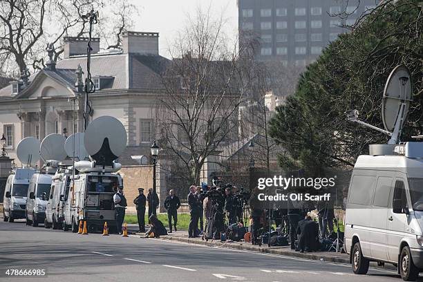 Television news crews report from outside Winfield House, the residence of the US Ambassador to the UK, where talks are taking place between US...