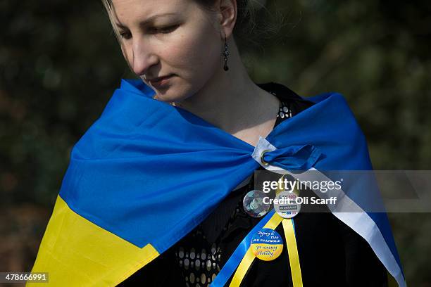 Protester wears a Ukrainian flag outside Winfield House, the residence of the US Ambassador to the UK, where talks are taking place between US...