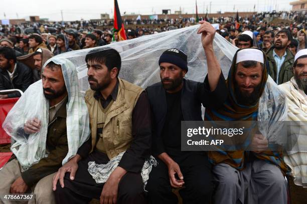 Supporters of Afghan presidential candidate and former Mujahideen leader and hardline Islamist Abdul Rasul Sayyaf gather during a political rally in...