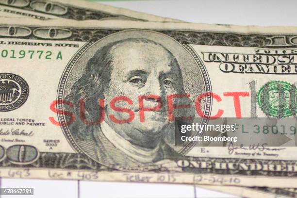 Counterfeit $100 bill sits in the counterfeit specimen vault at the U.S. Secret Service headquarters in Washington, D.C., U.S., on Wednesday, March...